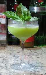Ginger Basil Gimlet cocktail with a sprig of basil for garnish