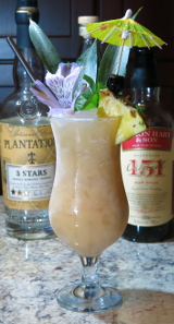A Pi&ntilde;a Colada cocktail with a mint and pineapple wedge garnish